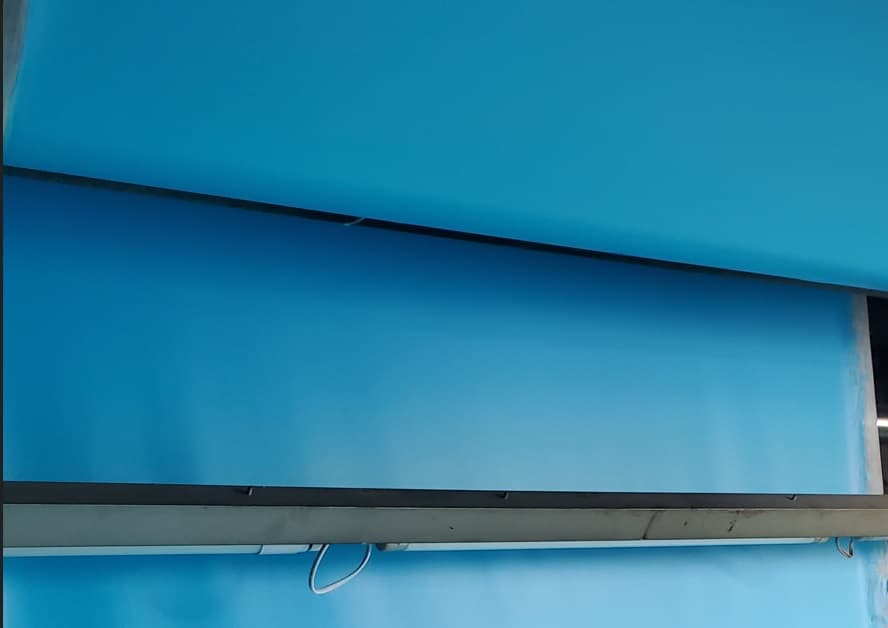 Vibrant blue panels separated by horizontal black bars with a white cable hanging below.
